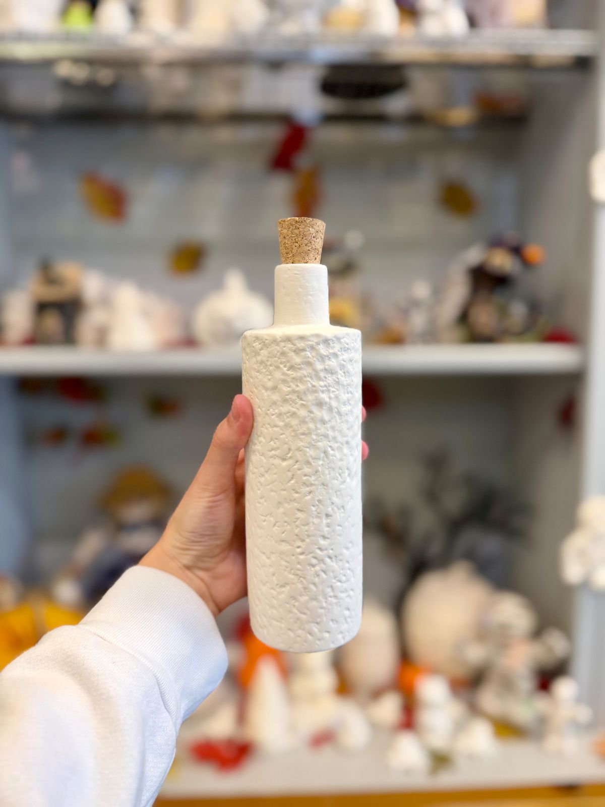 Textured white pottery bottle with a cork stopper from Paint Fusion